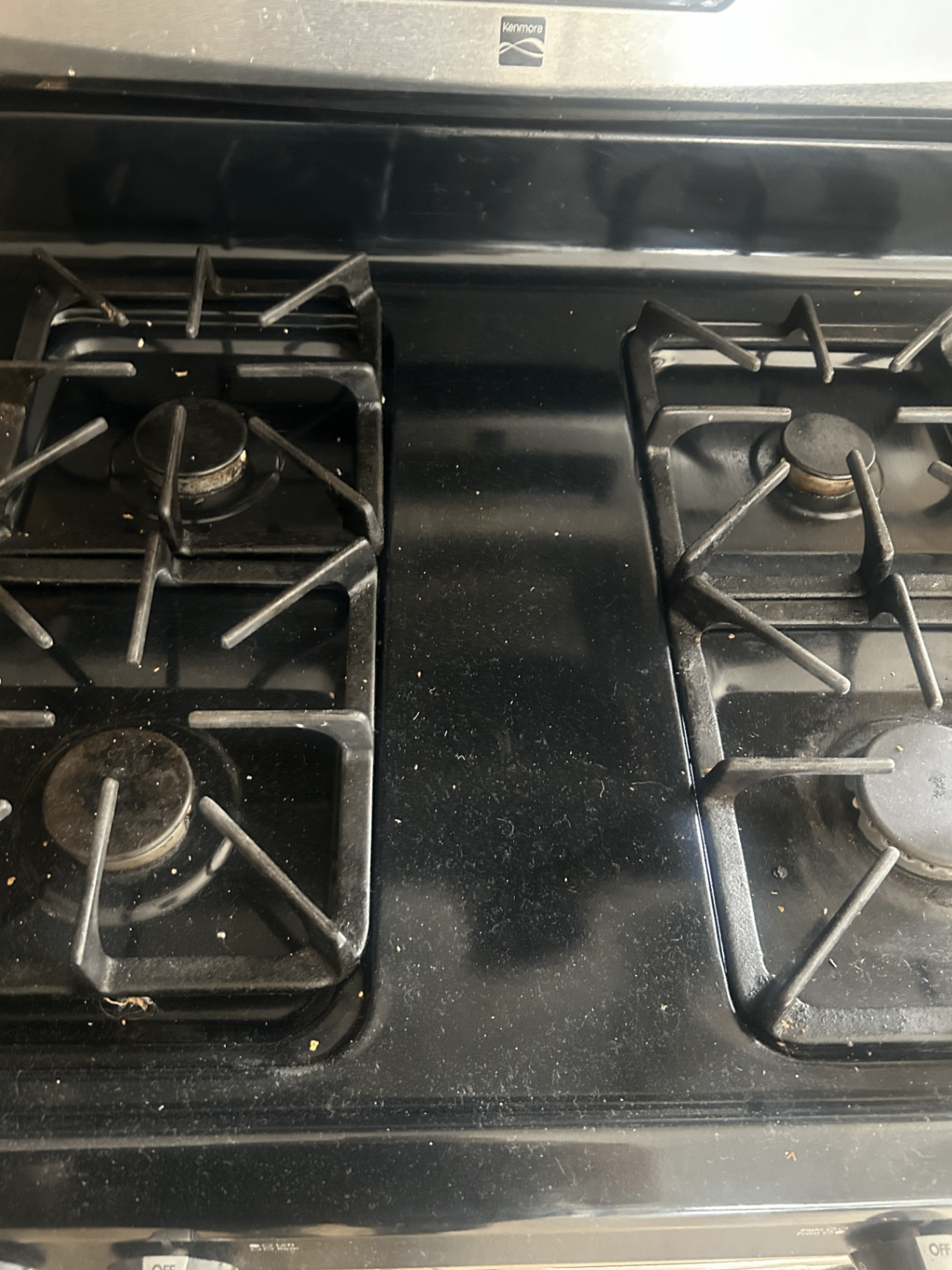 Stovetop before deep cleaning with crumbs and visible buildup