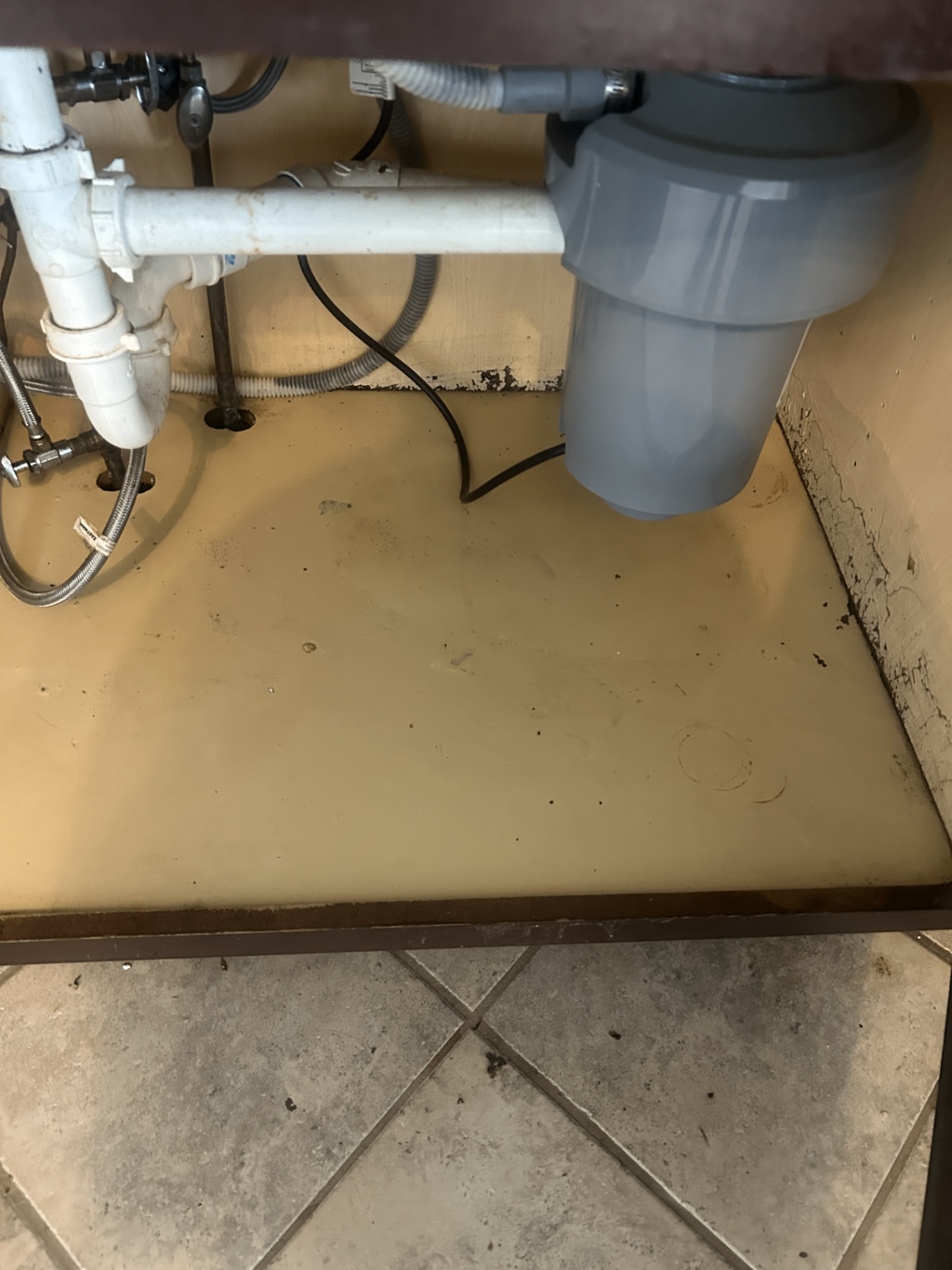 Under-sink cabinet after cleaning, bright and spotless